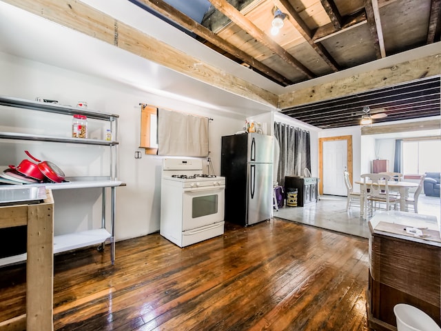 kitchen featuring dark wood-type flooring, ceiling fan, light brown cabinetry, gas range gas stove, and stainless steel refrigerator