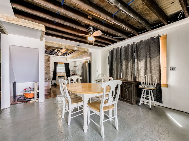 dining space with beam ceiling