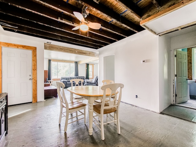 dining area with beam ceiling and ceiling fan