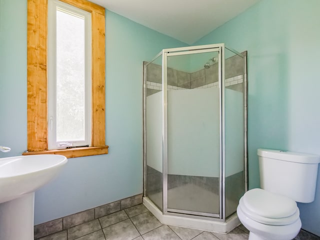 bathroom with tile patterned floors, a shower with door, and toilet