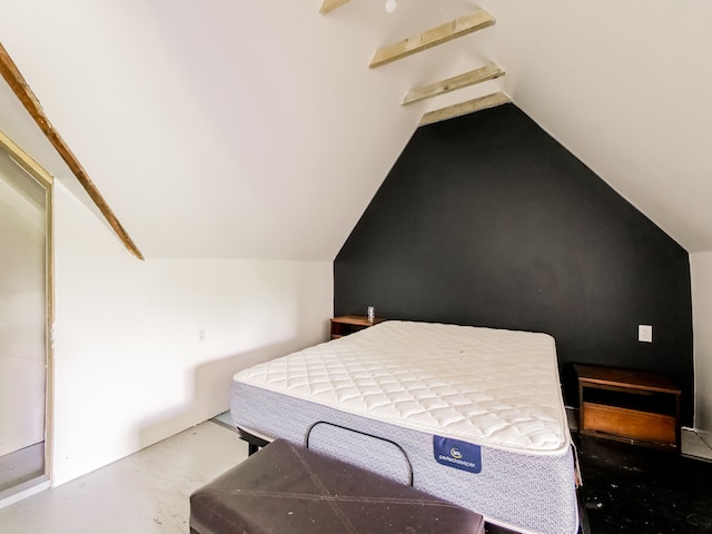 bedroom with vaulted ceiling with beams