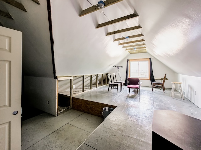 additional living space with vaulted ceiling with beams