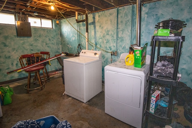 clothes washing area featuring electric panel and independent washer and dryer