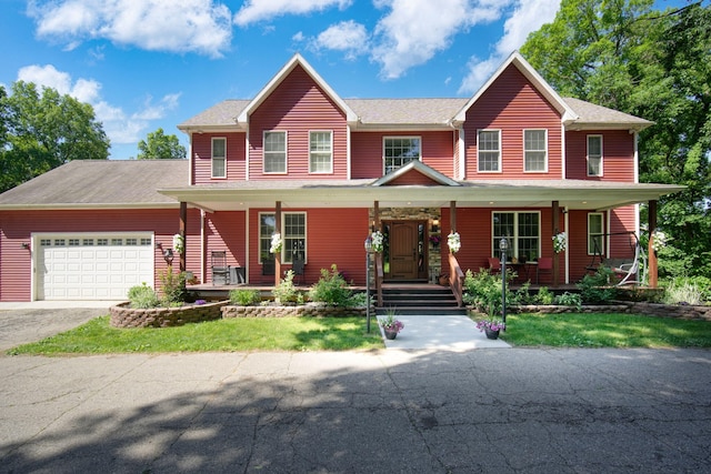 view of front facade featuring covered porch and a garage