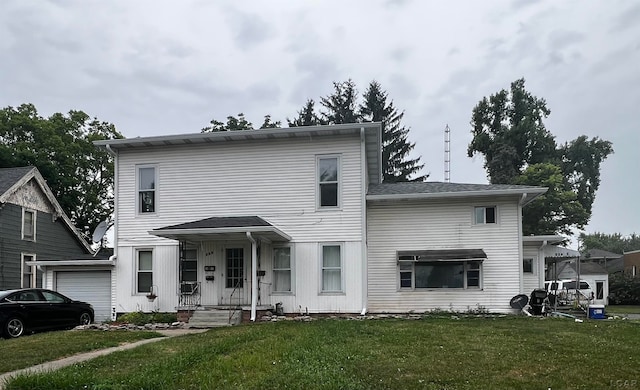 front facade with a garage and a front yard