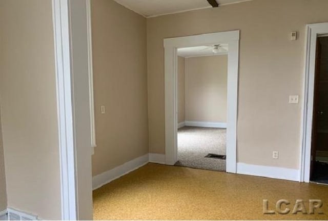 empty room featuring carpet flooring and ceiling fan