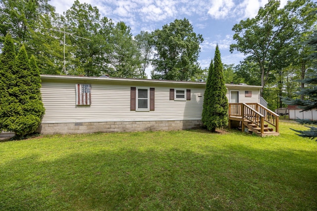 rear view of property with a yard