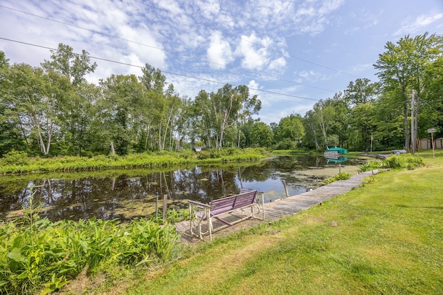 exterior space with a lawn and a water view