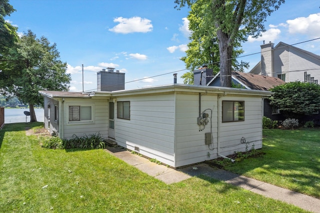 5149 Latimer St, West Bloomfield, MI 48324 - rear view of property with a lawn and a chimney