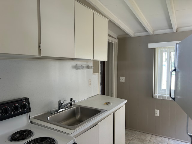 kitchen featuring beam ceiling, light tile patterned floors, wood walls, and range