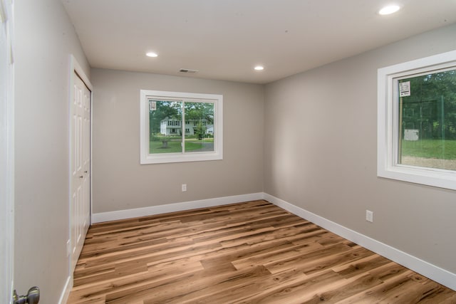 unfurnished bedroom featuring a closet and light hardwood / wood-style flooring