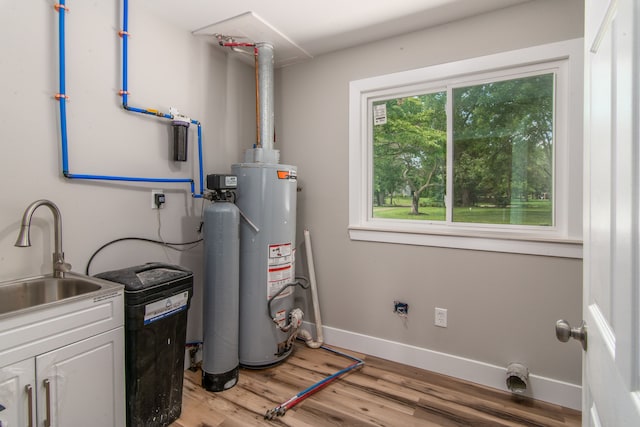 utility room with gas water heater and sink