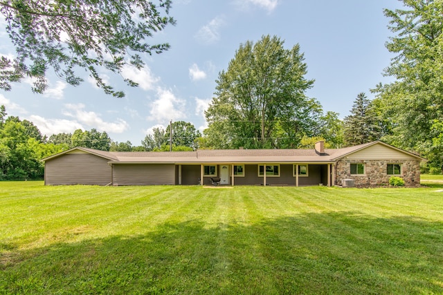 back of property featuring a yard and central AC unit