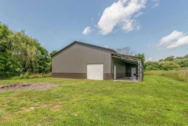 exterior space featuring a lawn and an outbuilding