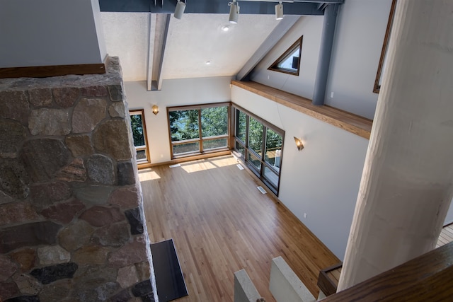 living room featuring hardwood / wood-style floors and lofted ceiling with beams