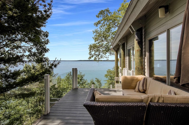 dock area with a balcony and a water view