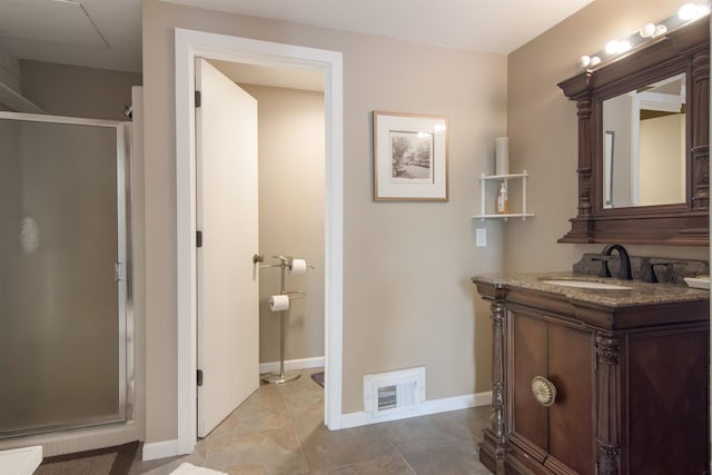 bathroom with tile patterned floors, vanity, and an enclosed shower