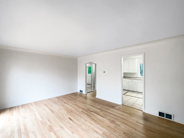 unfurnished room featuring light wood-type flooring