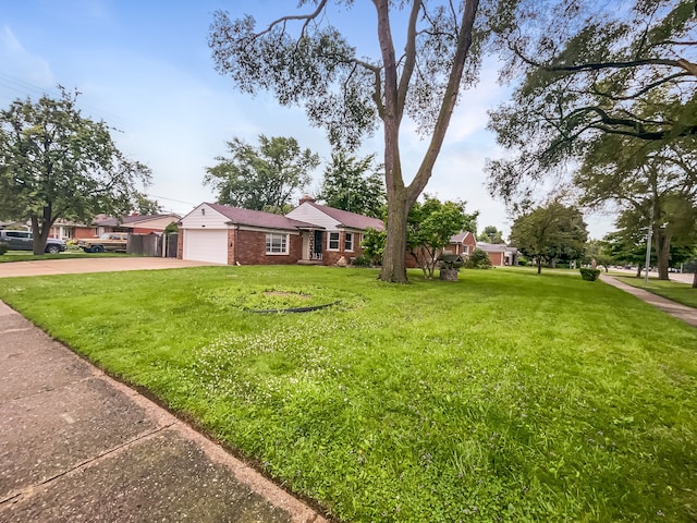 ranch-style house featuring a front yard and a garage