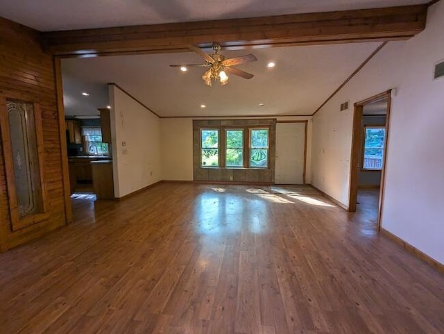 unfurnished room featuring beamed ceiling, hardwood / wood-style flooring, and ceiling fan