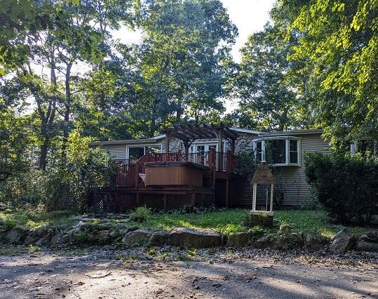 back of house with a pergola and a wooden deck