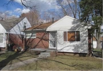 rear view of property with a yard