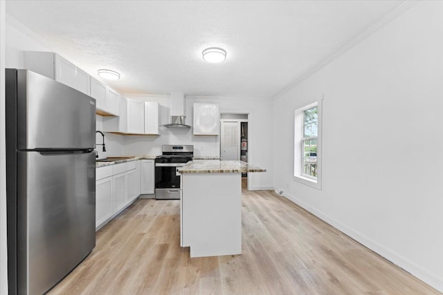 kitchen with a kitchen island, appliances with stainless steel finishes, light hardwood / wood-style floors, light stone counters, and white cabinetry