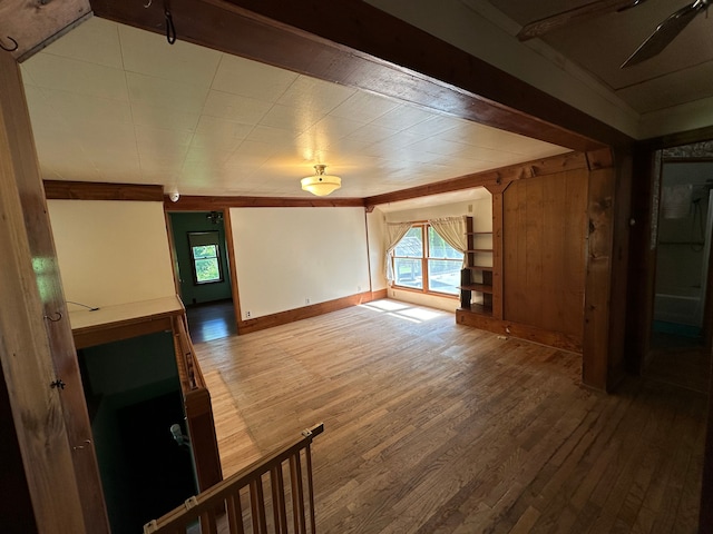 unfurnished living room featuring ceiling fan and hardwood / wood-style flooring