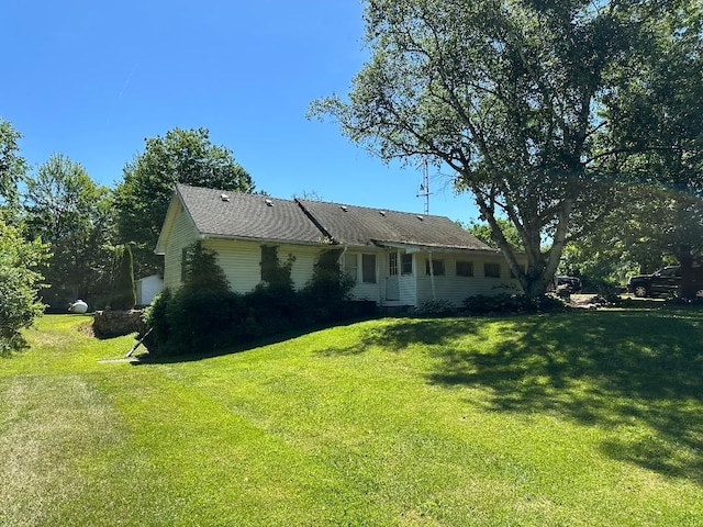 back of property featuring a yard