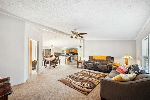 living room with ceiling fan, ornamental molding, and a textured ceiling