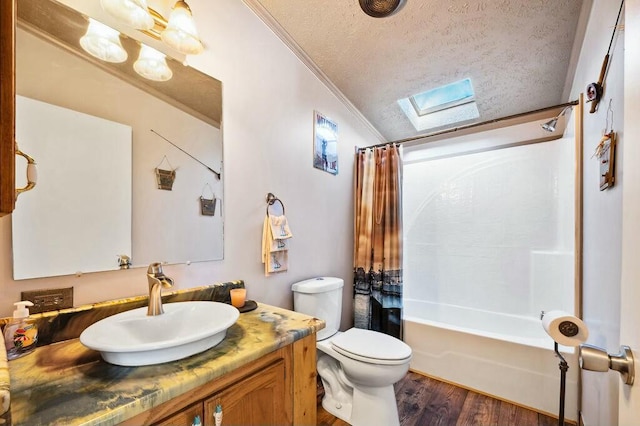 full bathroom with shower / bath combo, lofted ceiling with skylight, toilet, ornamental molding, and a textured ceiling