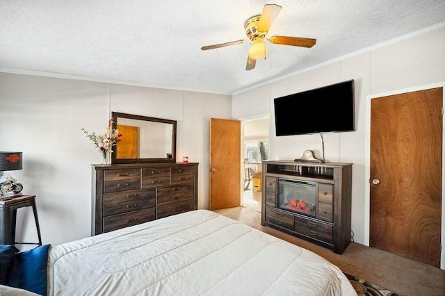 carpeted bedroom featuring ceiling fan, a fireplace, ornamental molding, and a textured ceiling