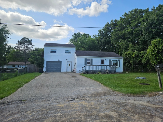 view of front facade featuring a garage, a deck, and a front lawn