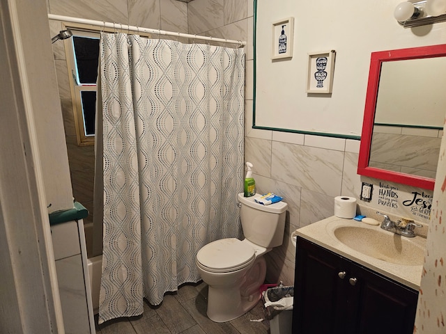 full bathroom featuring shower / bathtub combination with curtain, vanity, tile walls, and toilet