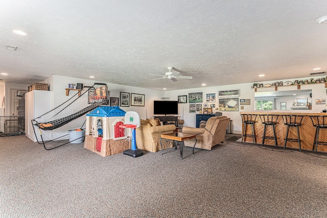 living room with ceiling fan, carpet, and a textured ceiling