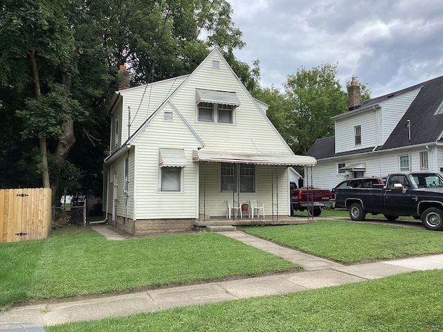 view of front of property with a porch and a front yard