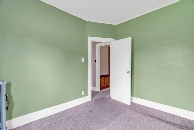 spare room featuring light carpet and ornamental molding