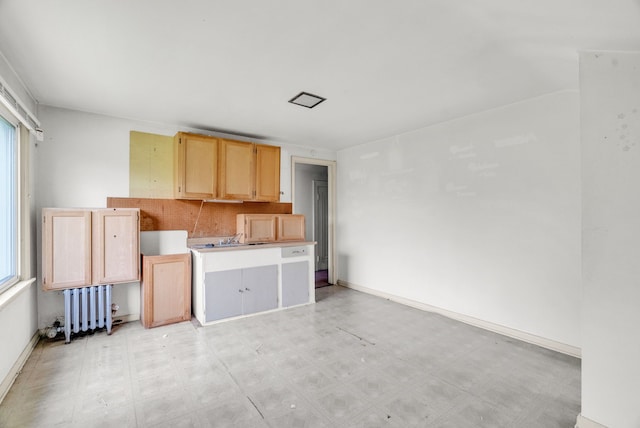 kitchen featuring light brown cabinets and radiator