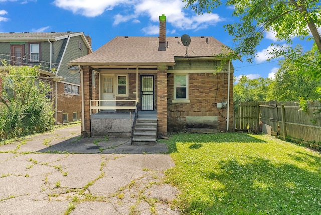 view of front of property with covered porch and a front yard