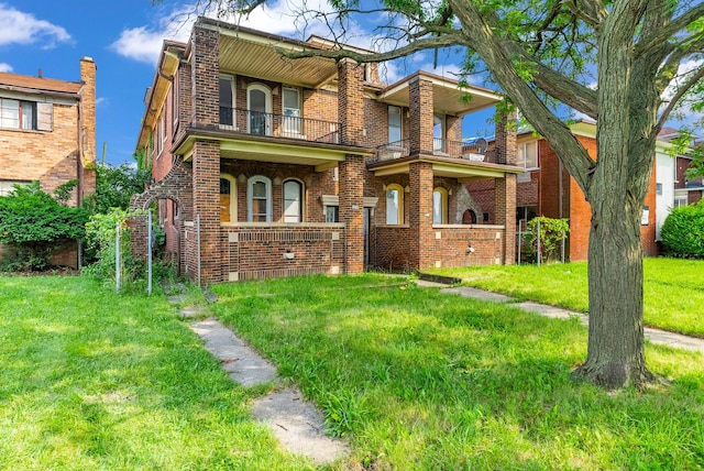 view of front of property featuring a balcony and a front lawn