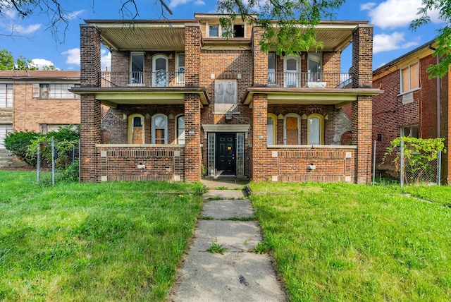 view of front of house featuring a front yard, a porch, and a balcony