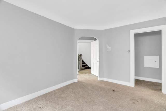 unfurnished room featuring light carpet