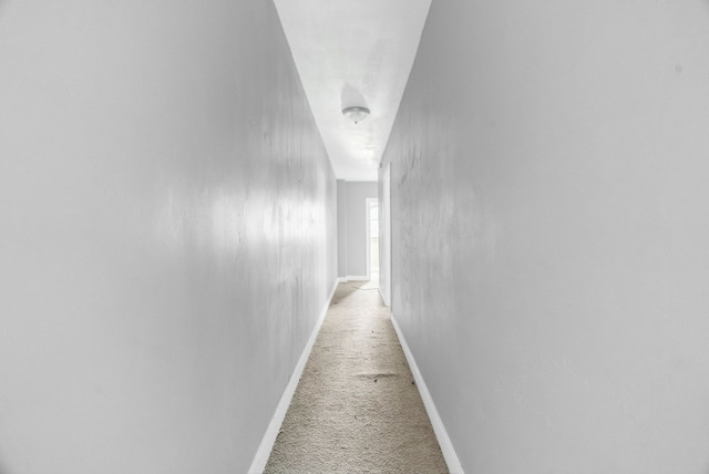 hallway with light colored carpet