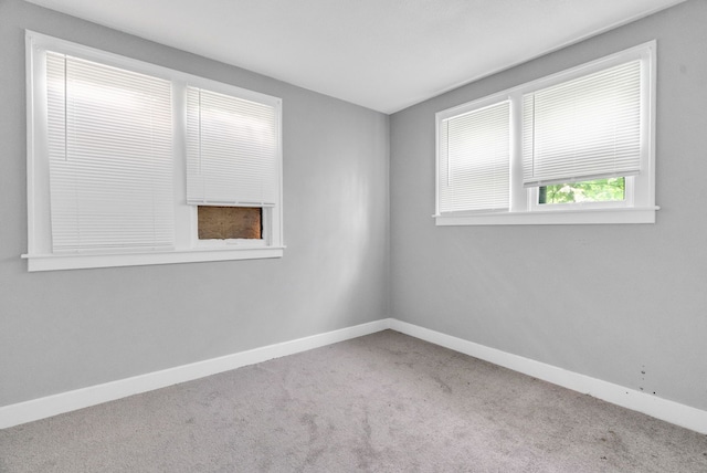 unfurnished room featuring light colored carpet