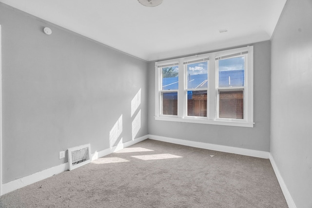 carpeted spare room with crown molding