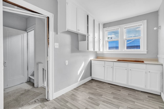 kitchen featuring white cabinetry and light wood-type flooring