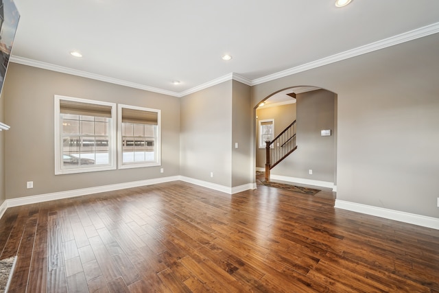 spare room featuring dark hardwood / wood-style floors and ornamental molding