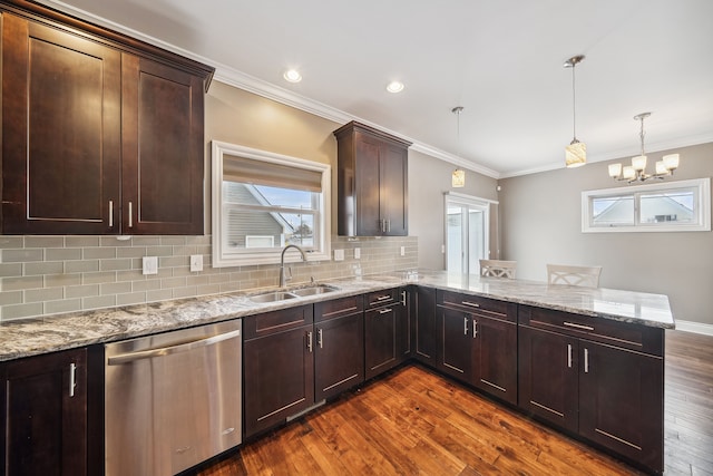 kitchen featuring dishwasher, pendant lighting, dark hardwood / wood-style flooring, and kitchen peninsula