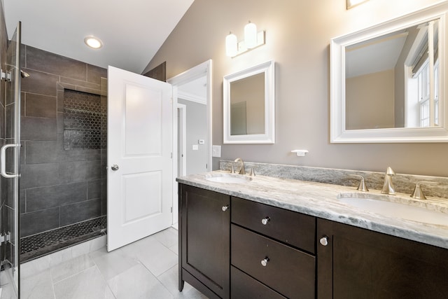 bathroom featuring vanity, tile patterned floors, walk in shower, and lofted ceiling