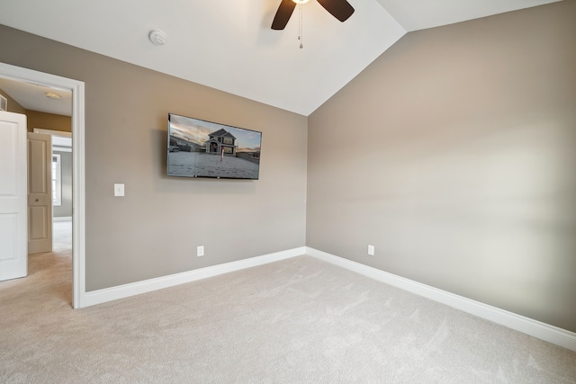 unfurnished room featuring light carpet, ceiling fan, and vaulted ceiling